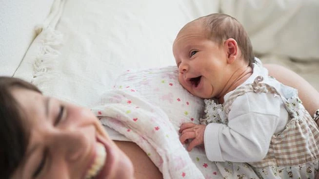 New mom snuggling newborn baby