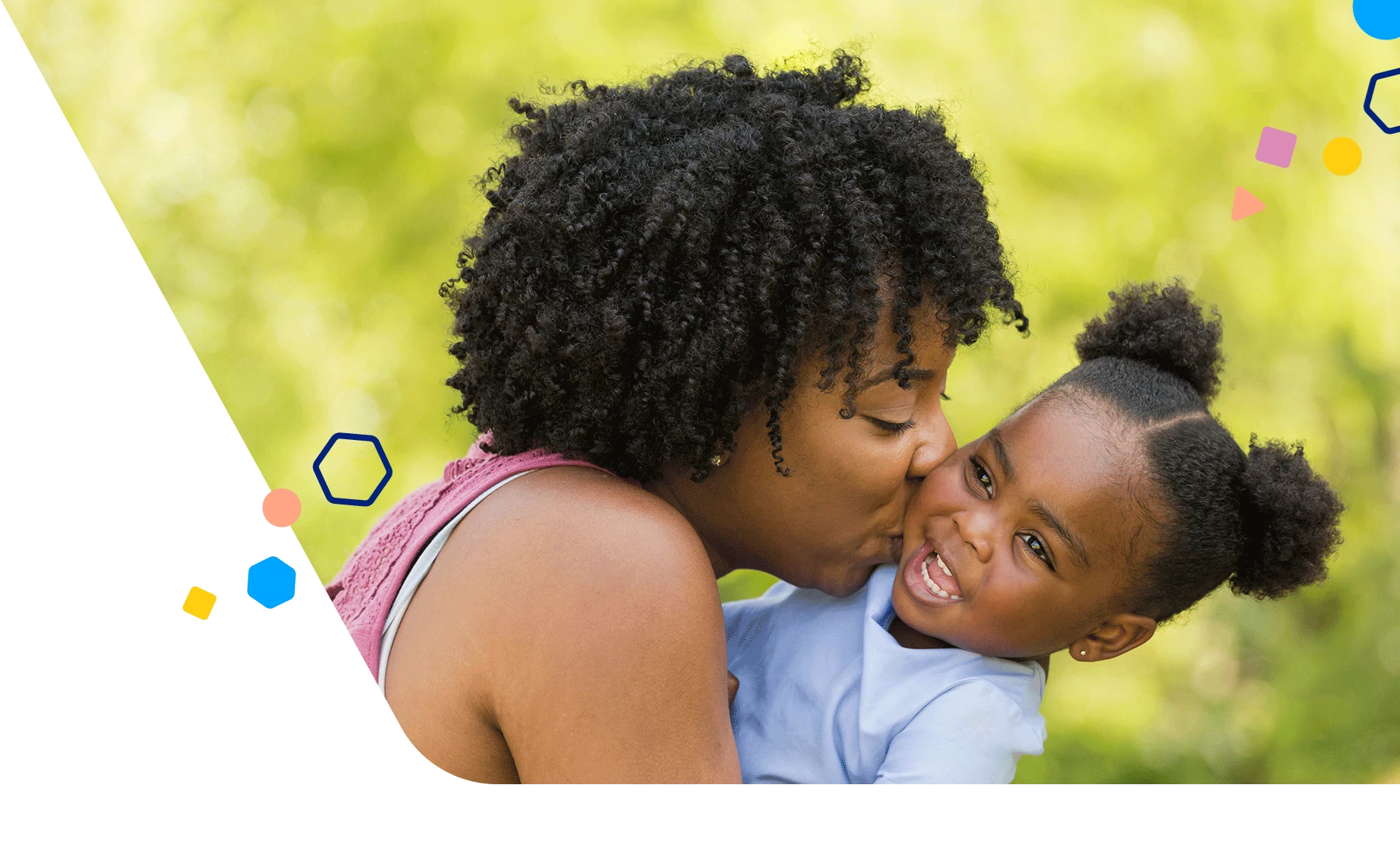 Mom kissing her toddler daughter on the cheek while outside