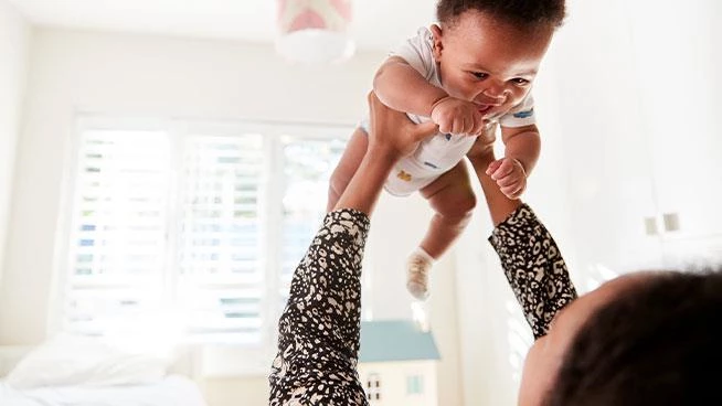 Mom lifting baby in the air