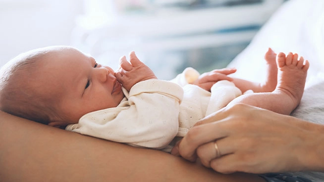 Baby looking up from mother's lap